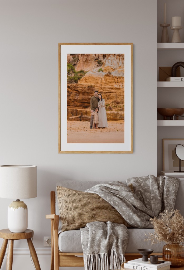 Framed family portrait artwork displayed above a sofa in a contemporary living room